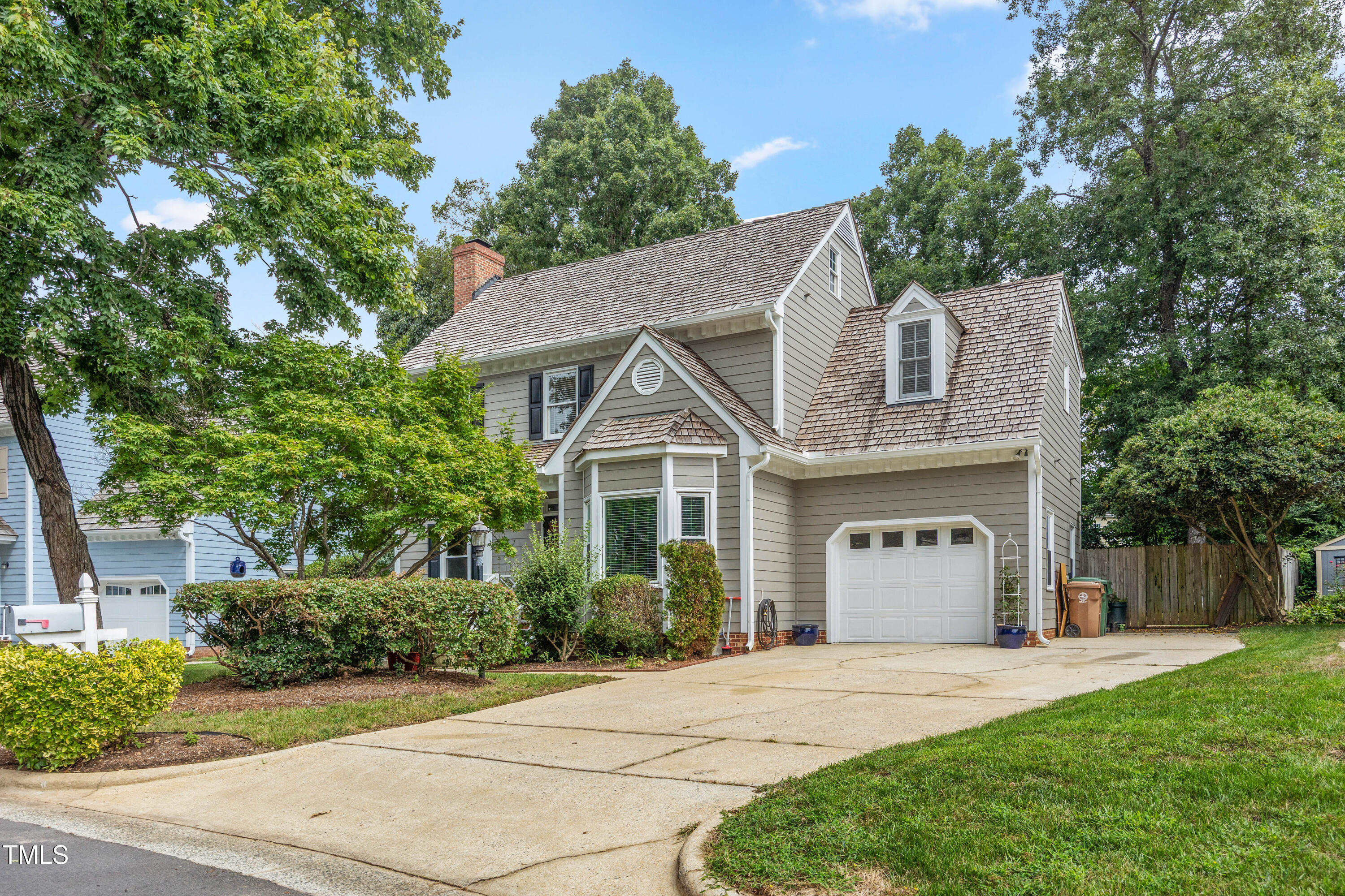 207 Wintermist Drive Cary, NC 27513 - Photo 2 of 43 a front view of a house with a yard and a garage