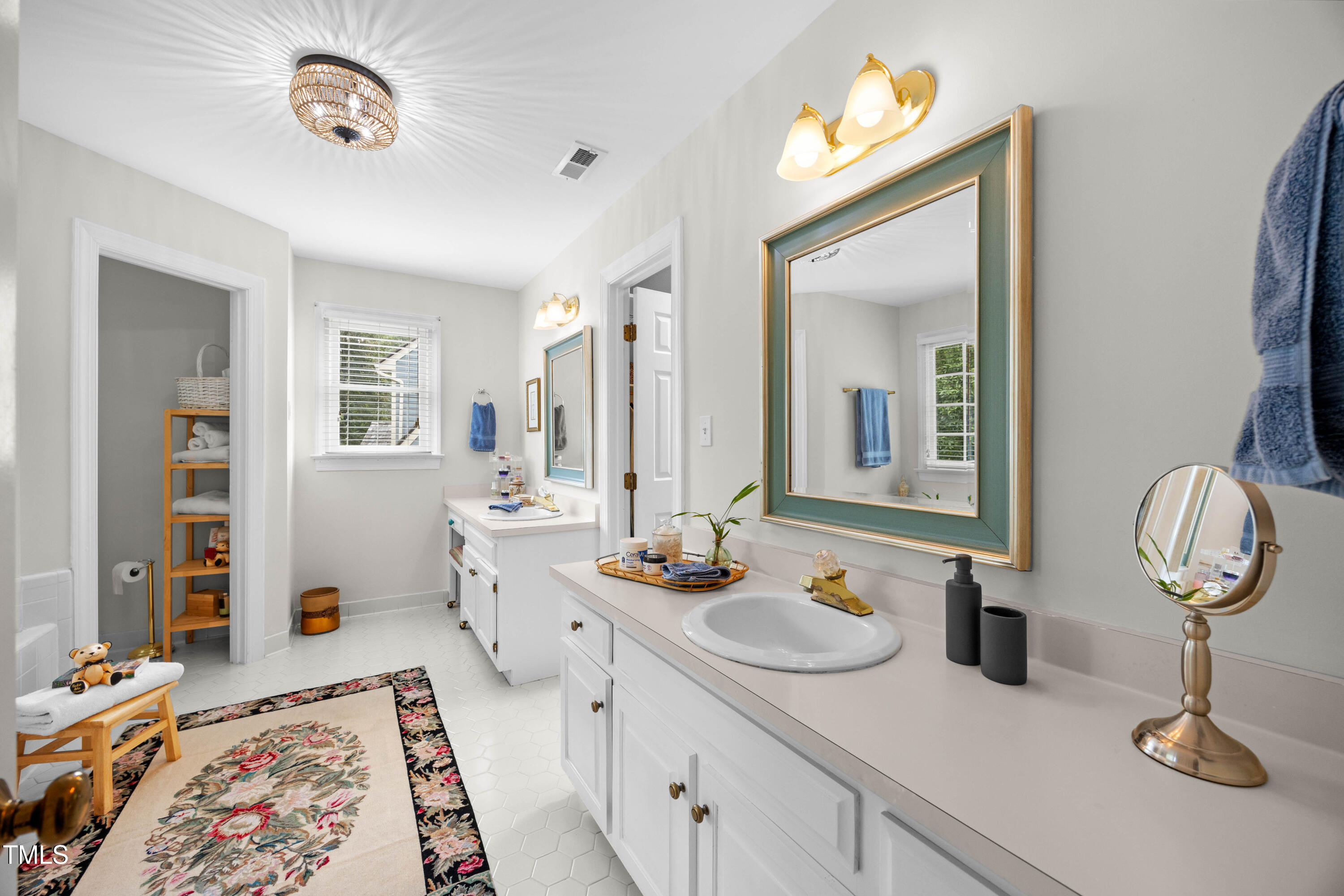 207 Wintermist Drive Cary, NC 27513 - Photo 22 of 43 a bathroom with double vanity sinks a mirror and a shower