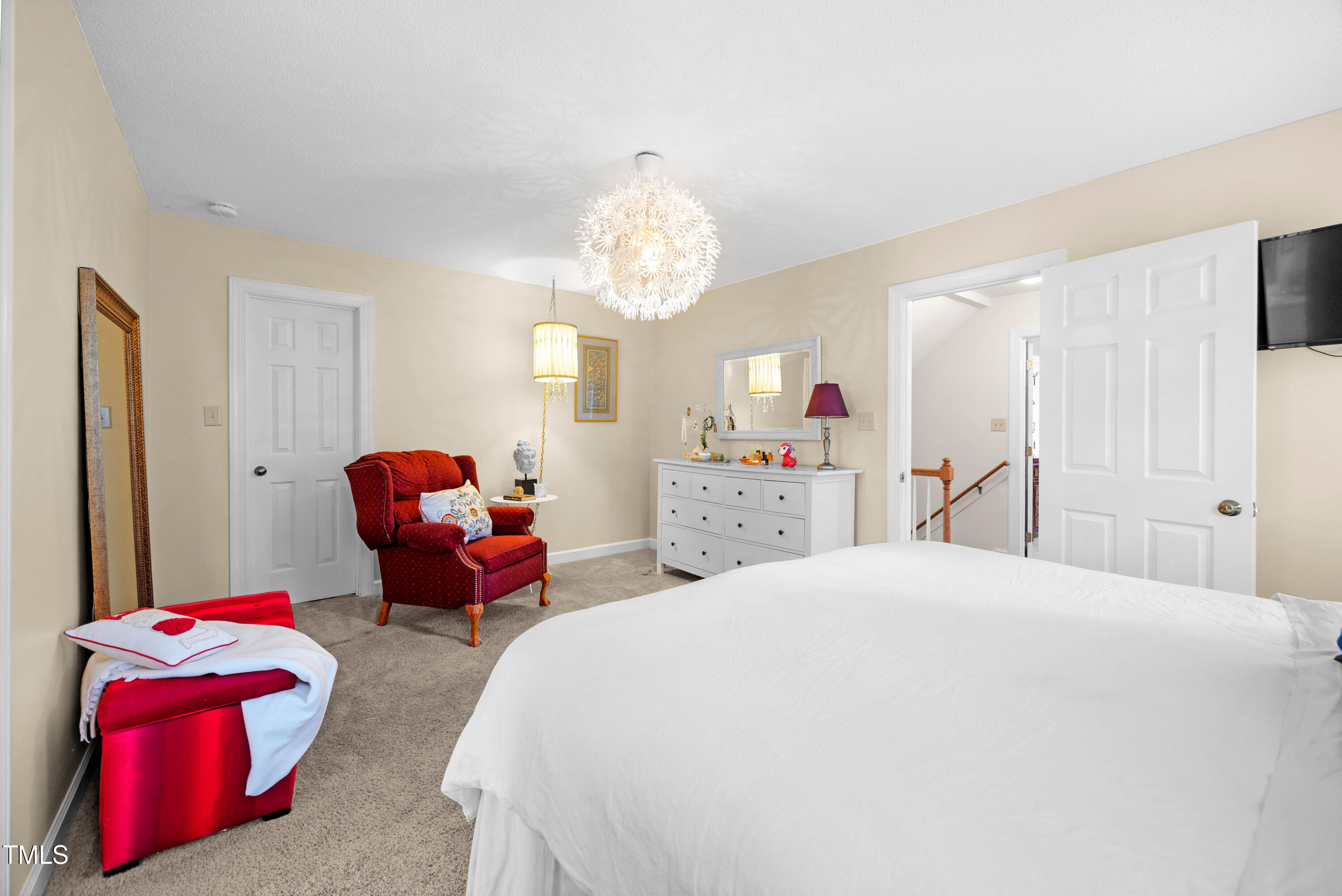 207 Wintermist Drive Cary, NC 27513 - Photo 25 of 43 a spacious bedroom with a bed and a chandelier