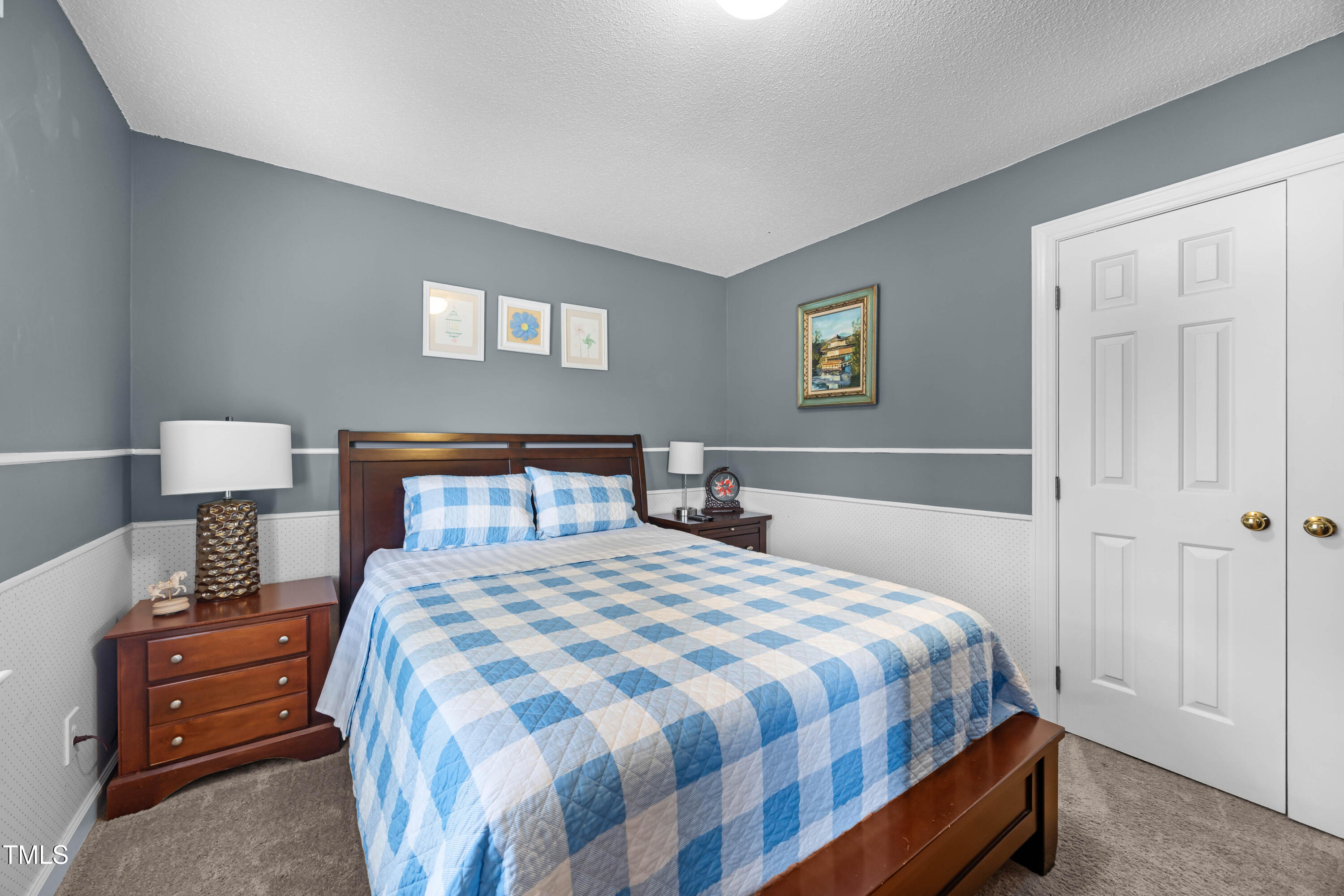 207 Wintermist Drive Cary, NC 27513 - Photo 29 of 43 a bedroom with a bed and a lamp