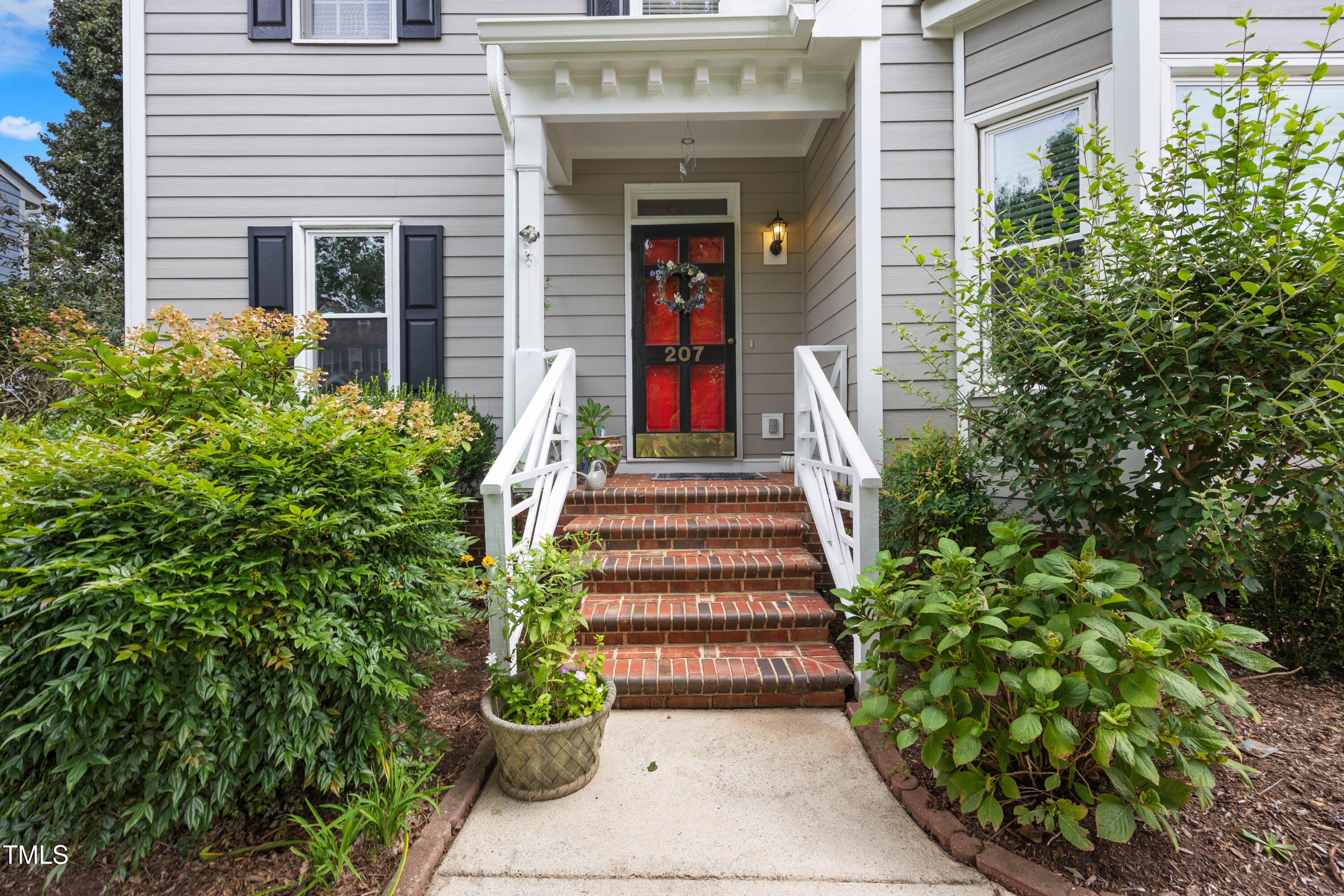 207 Wintermist Drive Cary, NC 27513 - Photo 3 of 43 a front view of a house with a garden