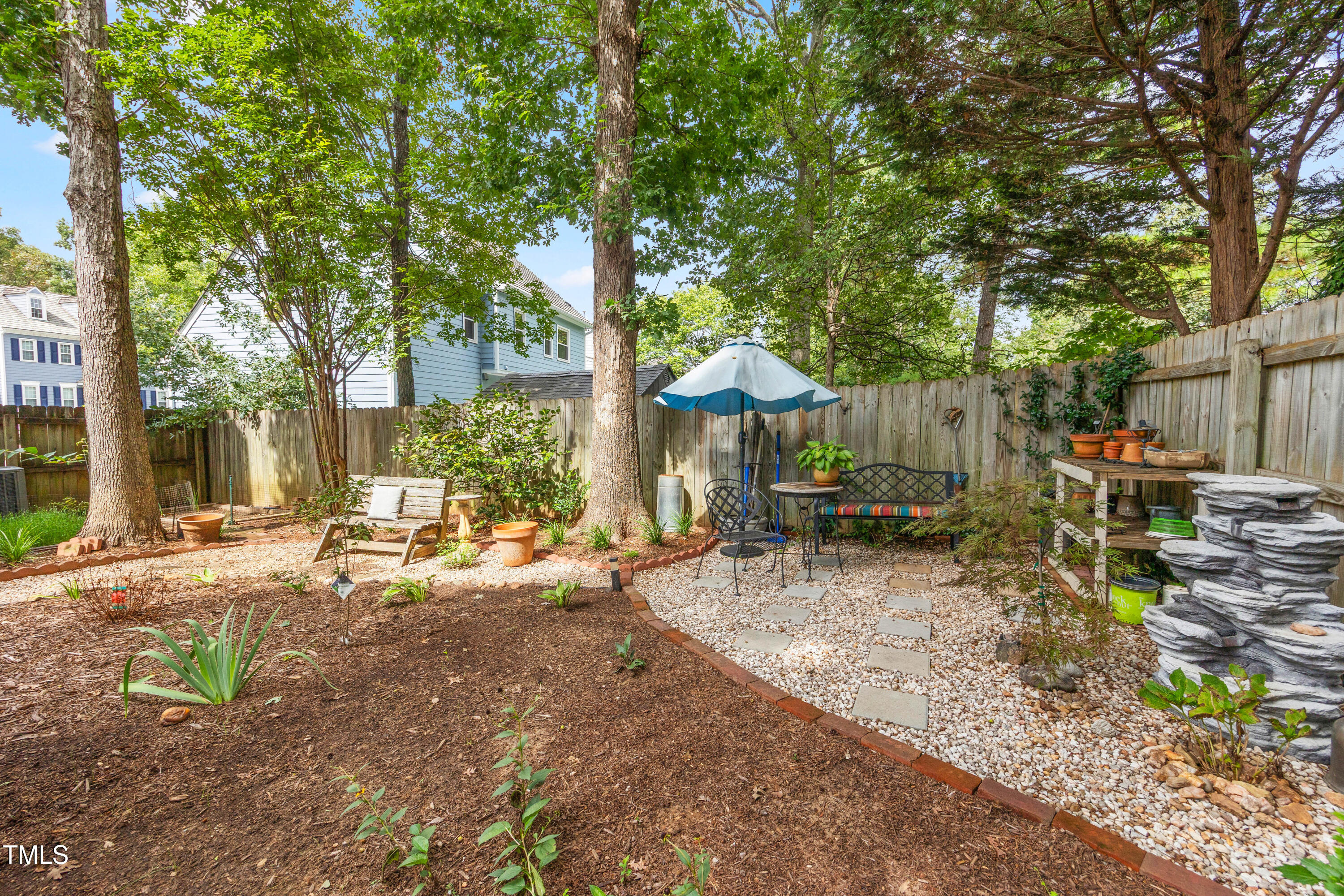 207 Wintermist Drive Cary, NC 27513 - Photo 39 of 43 a view of backyard with wooden fence and a large tree