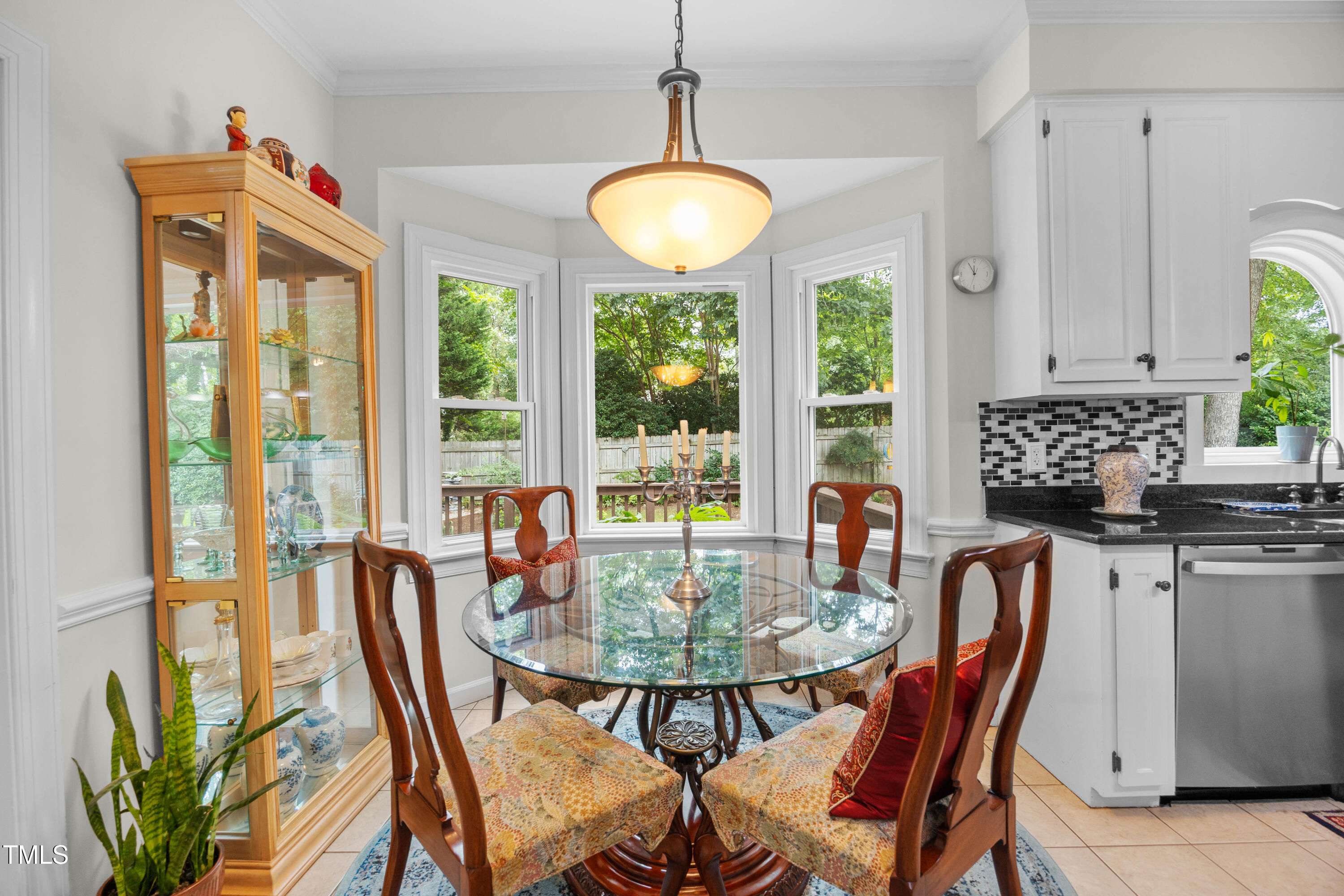 207 Wintermist Drive Cary, NC 27513 - Photo 6 of 43 a dining room with furniture a chandelier and a rug