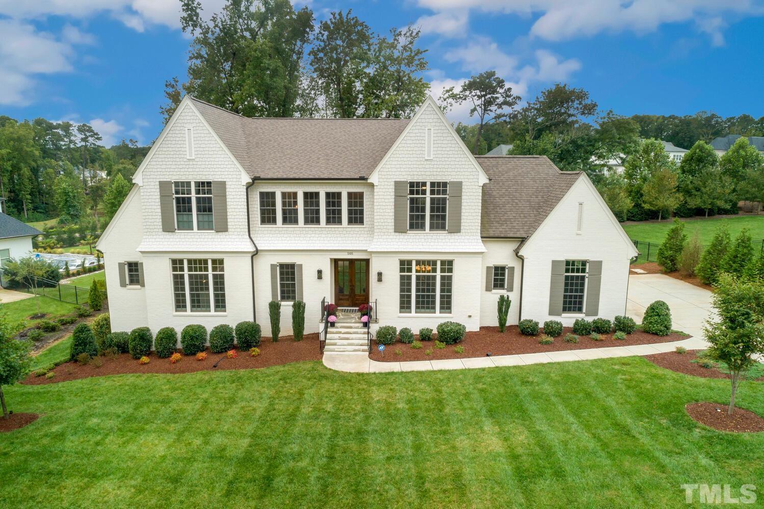 5105 Bella Ridge Drive Raleigh, NC 27615 - Photo 1 of 60 a front view of a house with a yard and potted plants