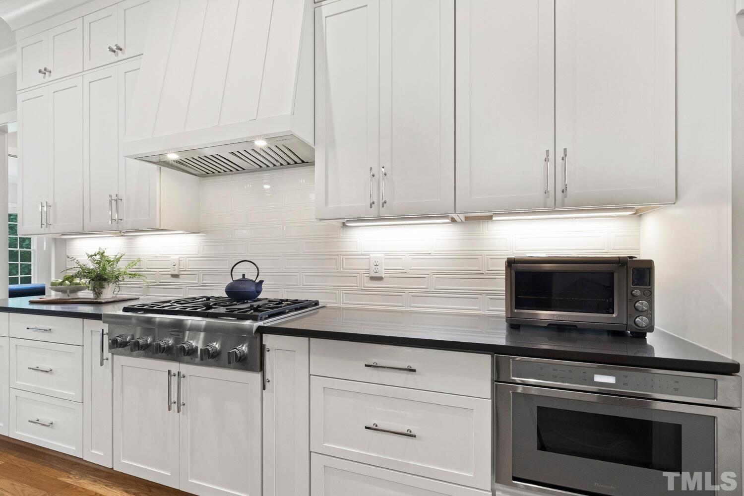5105 Bella Ridge Drive Raleigh, NC 27615 - Photo 15 of 60 a kitchen with granite countertop white cabinets stainless steel appliances and sink