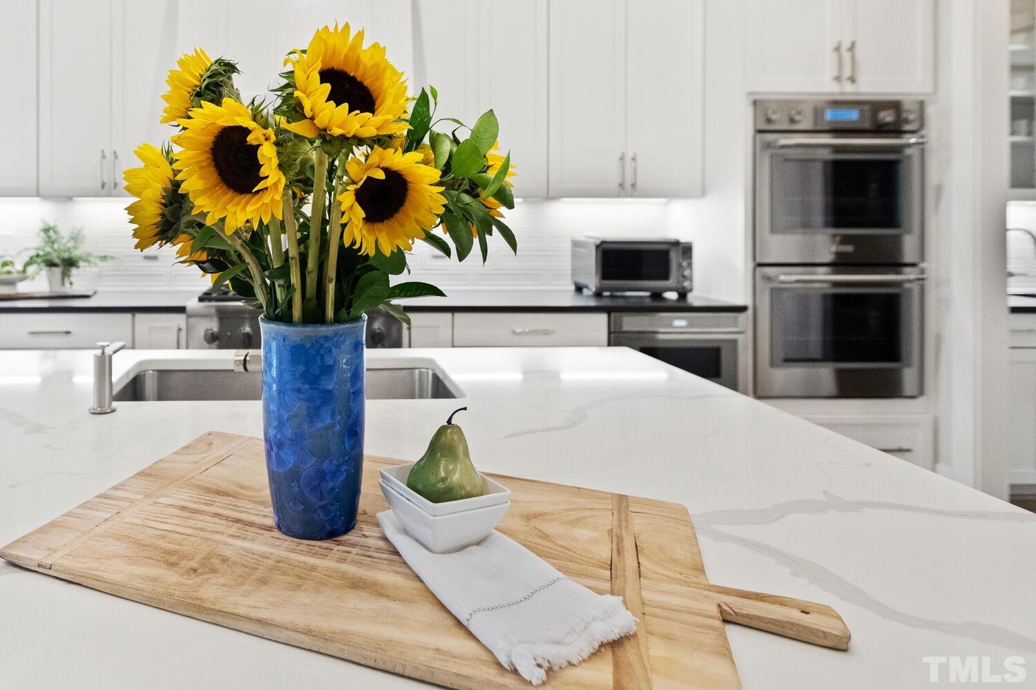 5105 Bella Ridge Drive Raleigh, NC 27615 - Photo 17 of 60 a vase of flowers sitting on a table