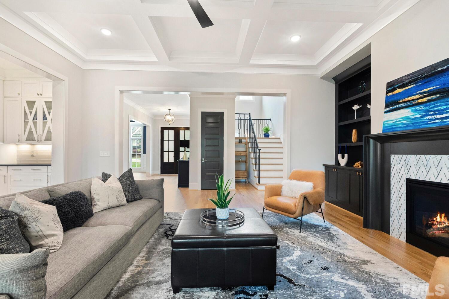5105 Bella Ridge Drive Raleigh, NC 27615 - Photo 22 of 60 a living room with furniture a fireplace and a flat screen tv