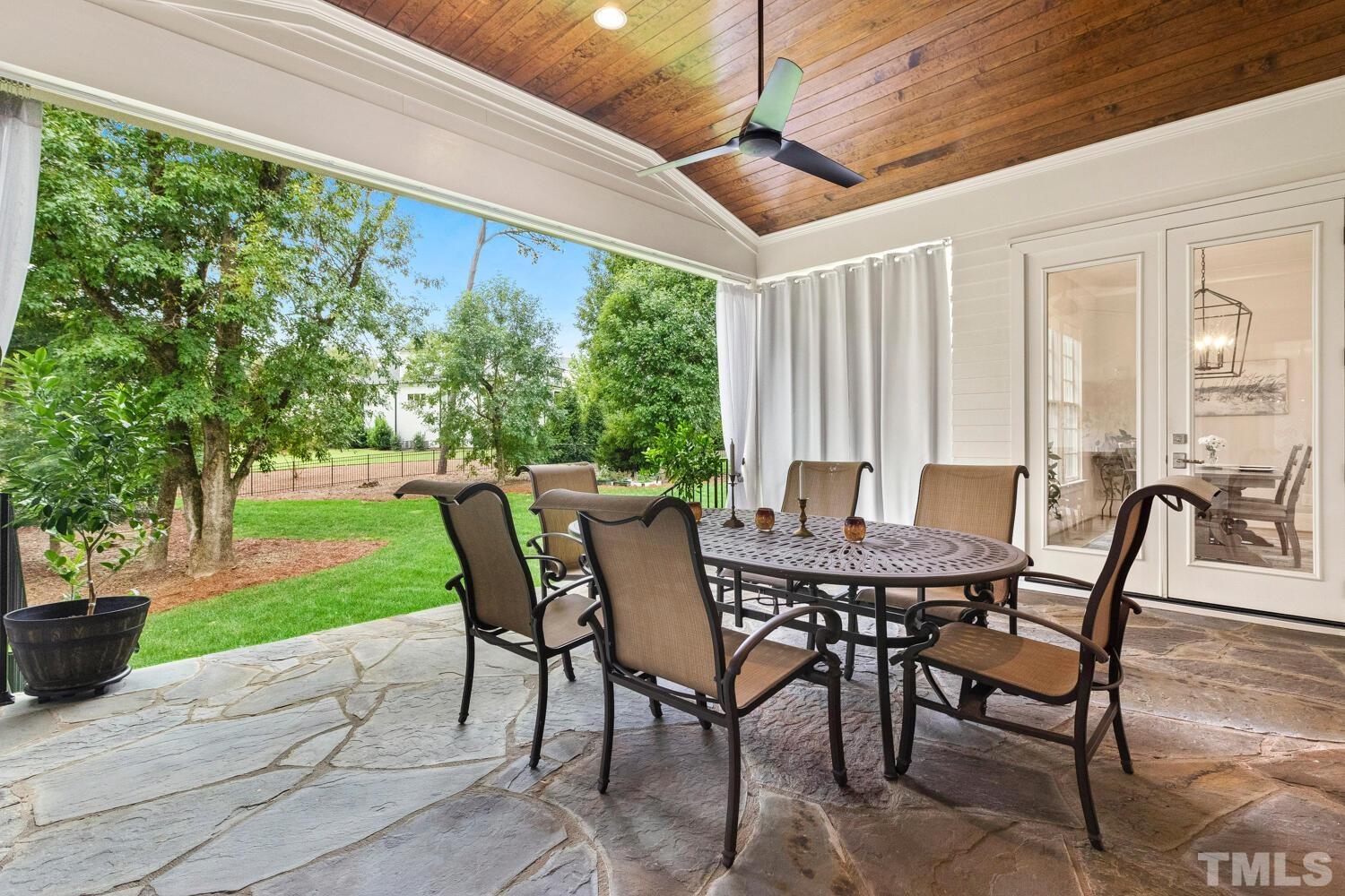 5105 Bella Ridge Drive Raleigh, NC 27615 - Photo 26 of 60 a view of an outdoor dining space with furniture and garden