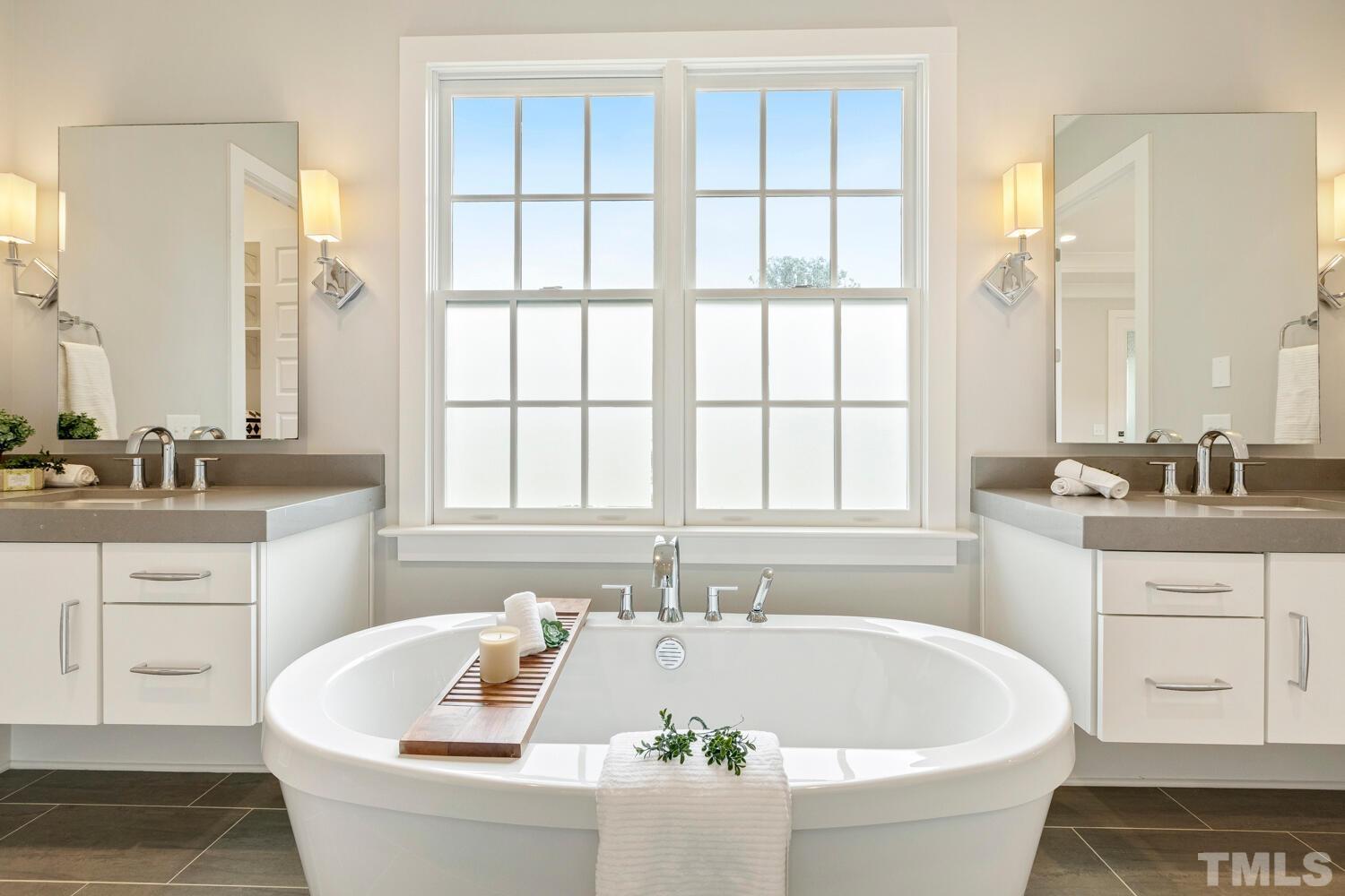 5105 Bella Ridge Drive Raleigh, NC 27615 - Photo 29 of 60 a white bath tub sitting in a bathroom next to a window