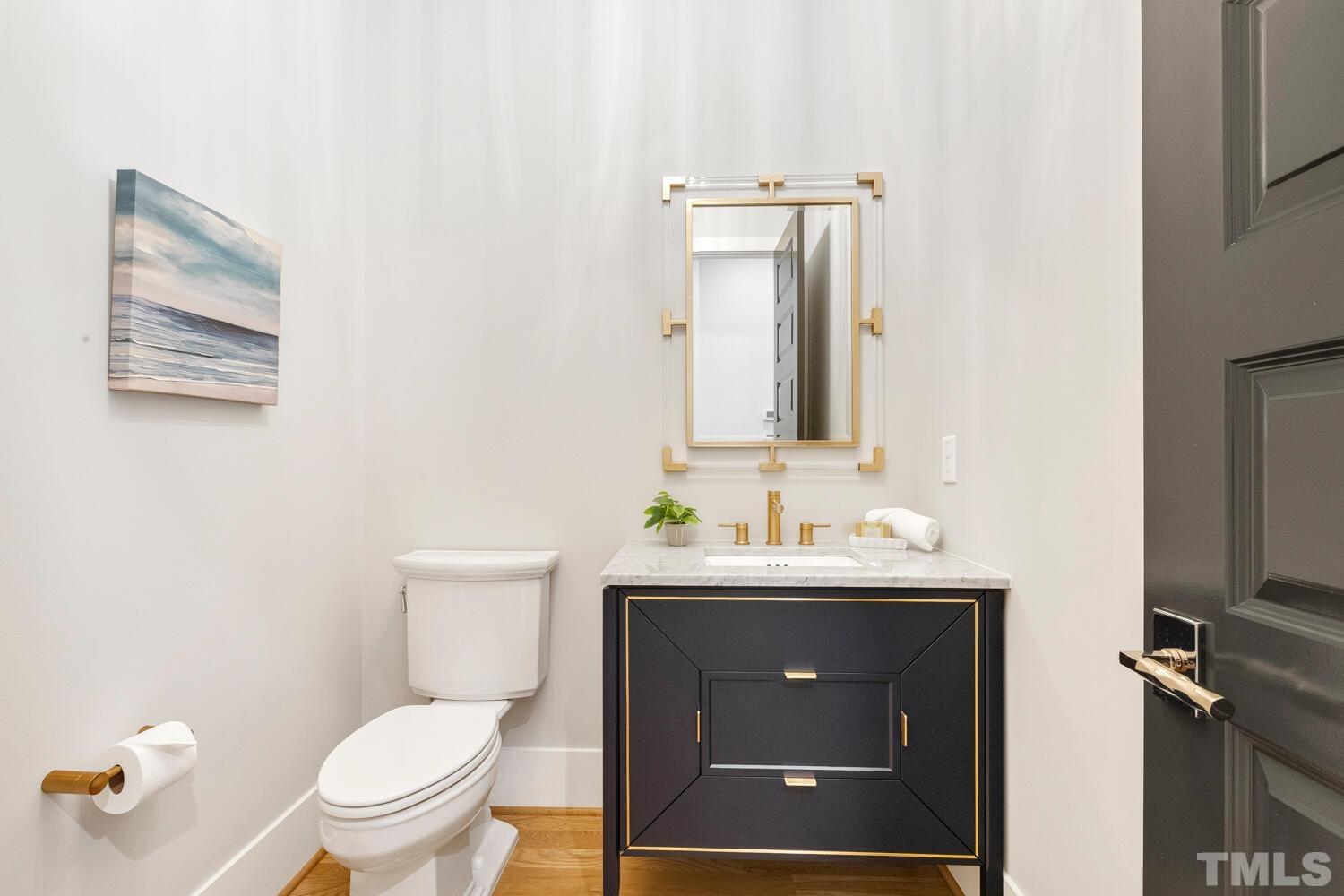 5105 Bella Ridge Drive Raleigh, NC 27615 - Photo 32 of 60 a bathroom with a toilet sink and mirror