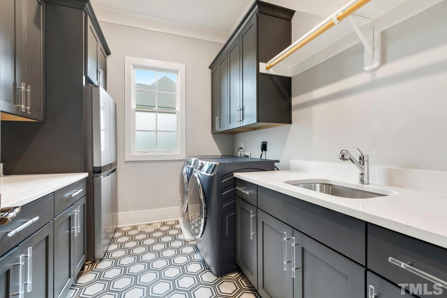 5105 Bella Ridge Drive Raleigh, NC 27615 - Photo 39 of 60 a utility room with cabinets washer and dryer