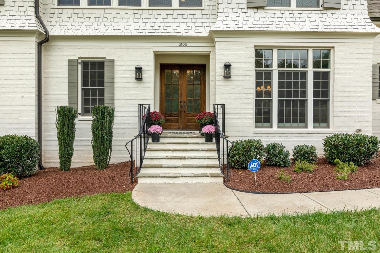 5105 Bella Ridge Drive Raleigh, NC 27615 - Photo 4 of 60 a front view of a house with a yard and potted plants