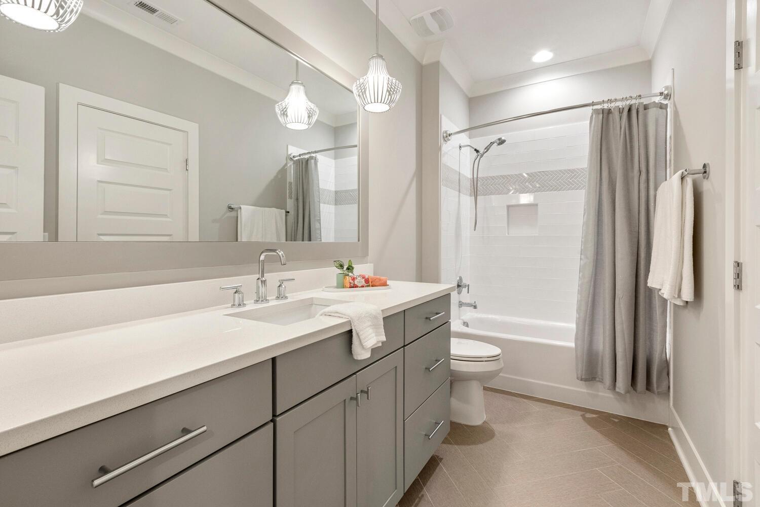 5105 Bella Ridge Drive Raleigh, NC 27615 - Photo 47 of 60 a bathroom with a shower sink vanity mirror and toilet