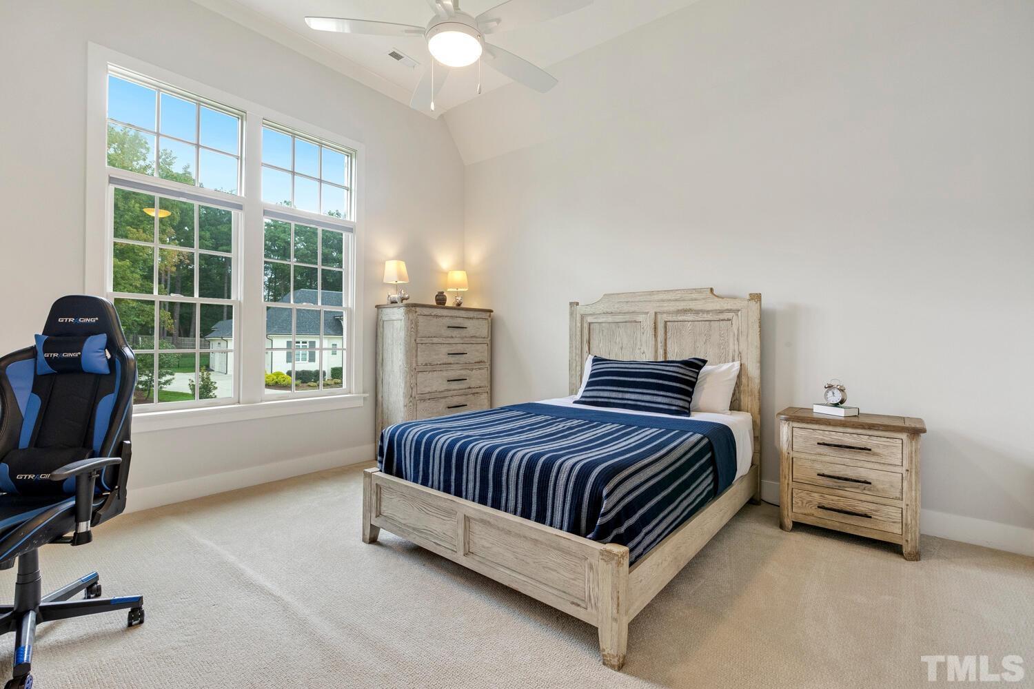 5105 Bella Ridge Drive Raleigh, NC 27615 - Photo 48 of 60 a spacious bedroom with a bed and a desk