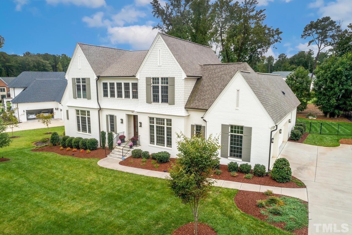 5105 Bella Ridge Drive Raleigh, NC 27615 - Photo 50 of 60 a front view of a house with a yard table and chairs