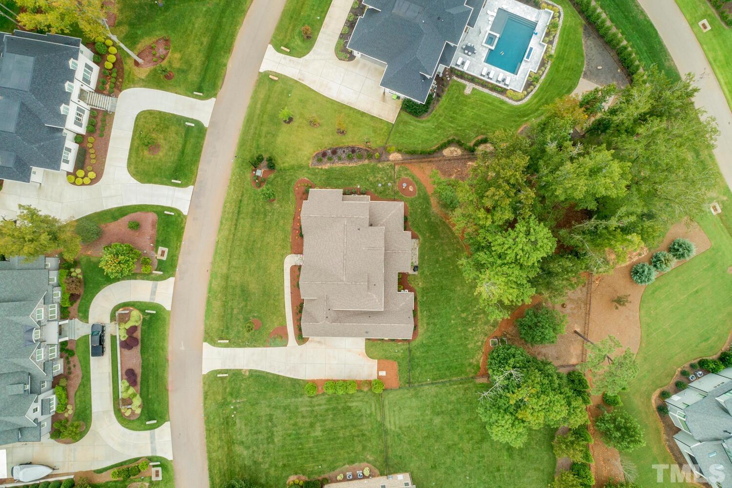 5105 Bella Ridge Drive Raleigh, NC 27615 - Photo 57 of 60 an aerial view of a house with a garden and swimming pool