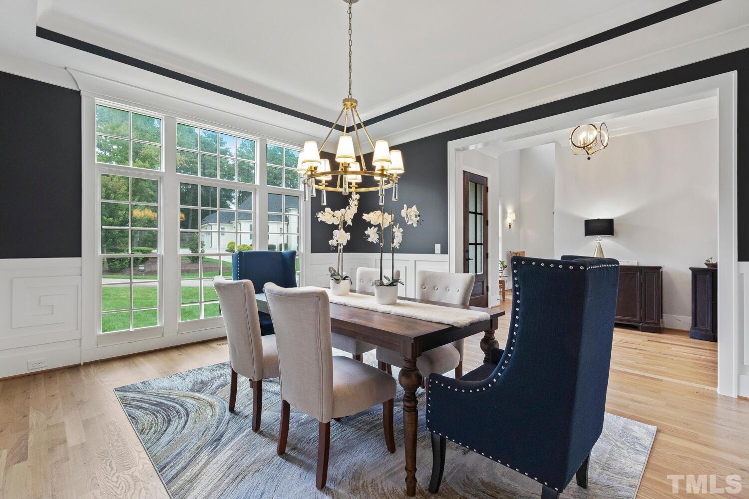 5105 Bella Ridge Drive Raleigh, NC 27615 - Photo 9 of 60 a dining room with furniture a chandelier and wooden floor
