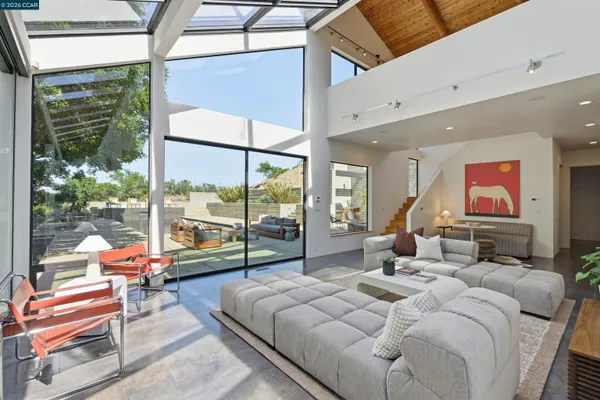 a bedroom with a bed and large window