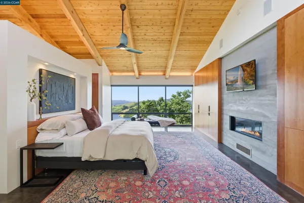 a bedroom with a bed and a large window