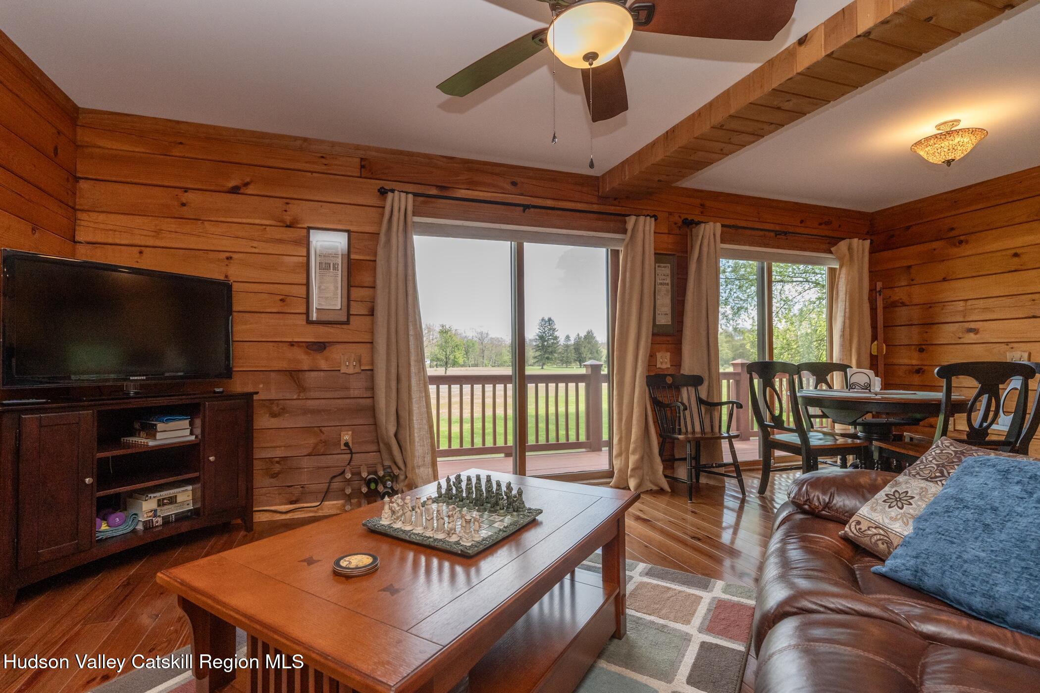 140 Stone Dock Road High Falls, NY 12440 - Photo 9 of 42 a living room with furniture a flat screen tv and a large window