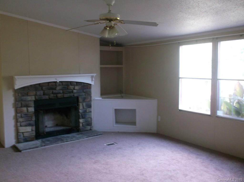 1264 Raxter Road Edgemoor, SC 29712 - Photo 7 of 21 an empty room with windows and fireplace