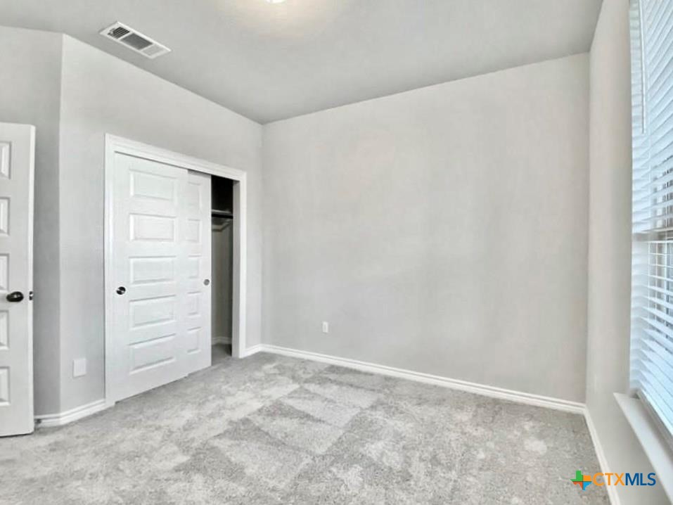 816 Alta Way Leander, TX 78641 - Photo 12 of 37 an empty room with closet and window