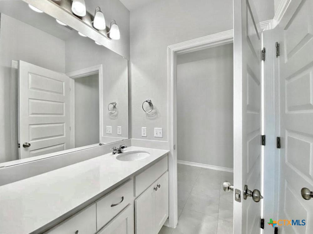 816 Alta Way Leander, TX 78641 - Photo 14 of 37 a bathroom with a sink a light fixture and a mirror