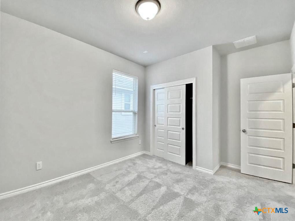 816 Alta Way Leander, TX 78641 - Photo 17 of 37 an empty room with closet and windows