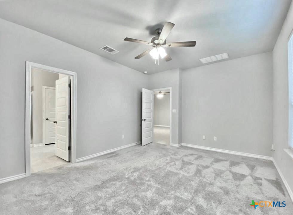 816 Alta Way Leander, TX 78641 - Photo 25 of 37 an empty room with closet and fan