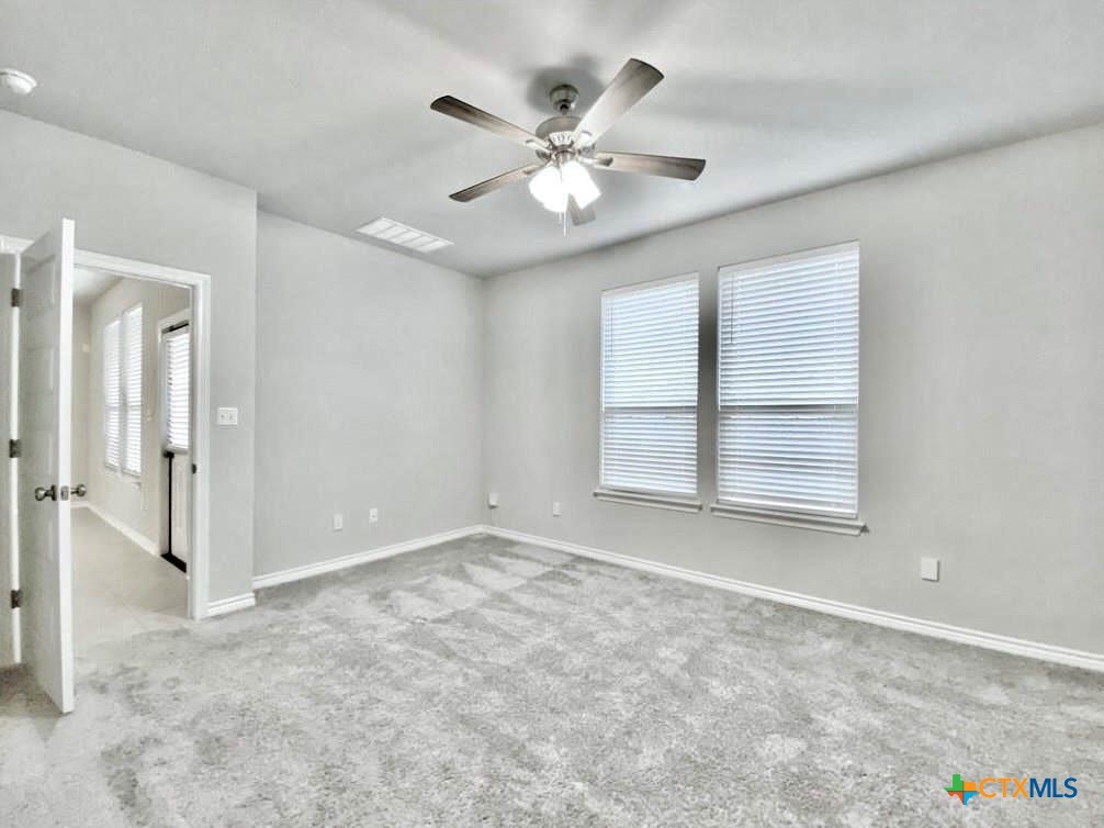 816 Alta Way Leander, TX 78641 - Photo 26 of 37 an empty room with windows and ceiling fan