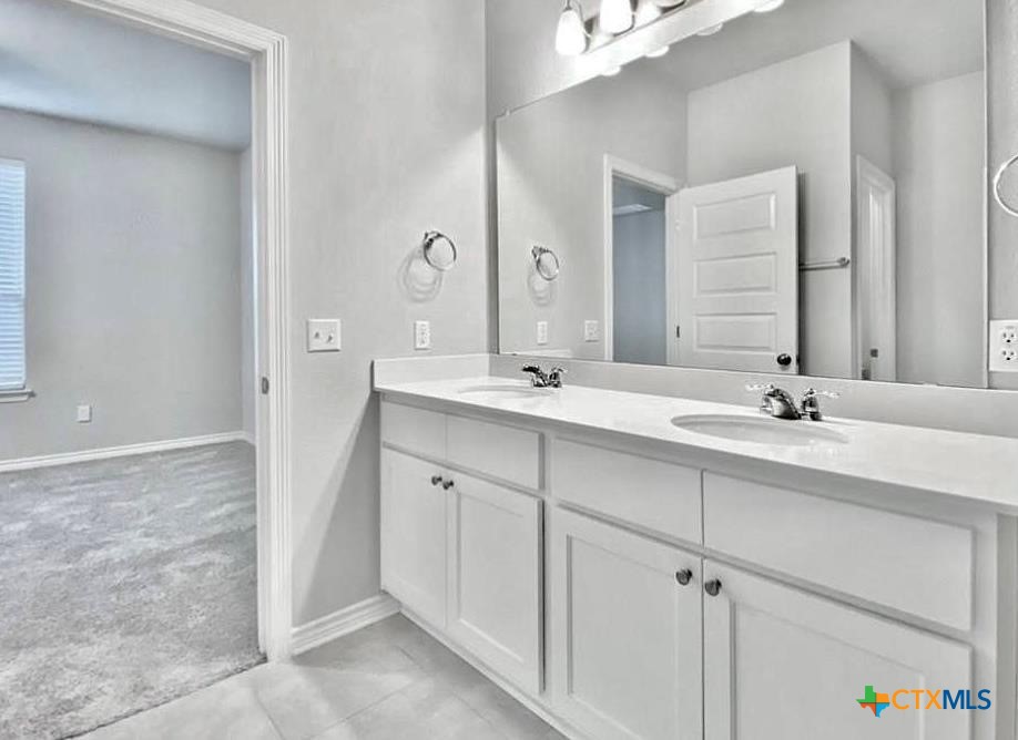 816 Alta Way Leander, TX 78641 - Photo 28 of 37 a bathroom with double sink and a mirror