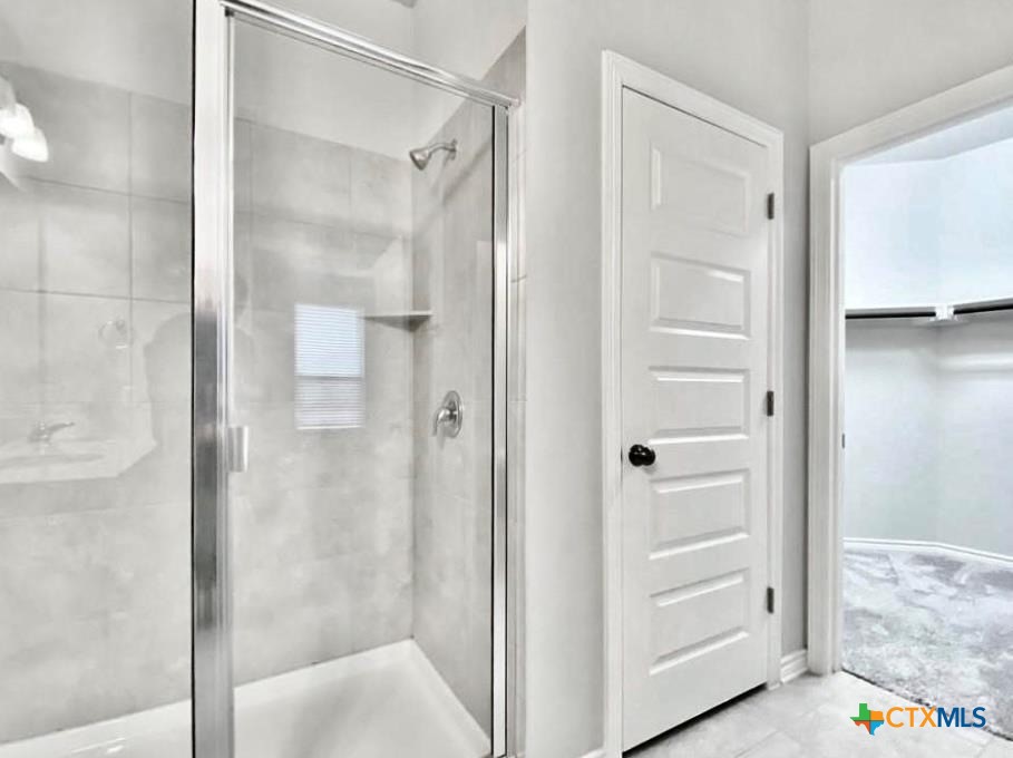816 Alta Way Leander, TX 78641 - Photo 31 of 37 a bathroom with a glass shower door