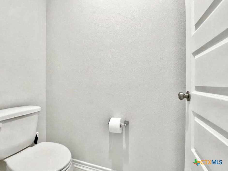 816 Alta Way Leander, TX 78641 - Photo 32 of 37 a white toilet sitting next to a white wall