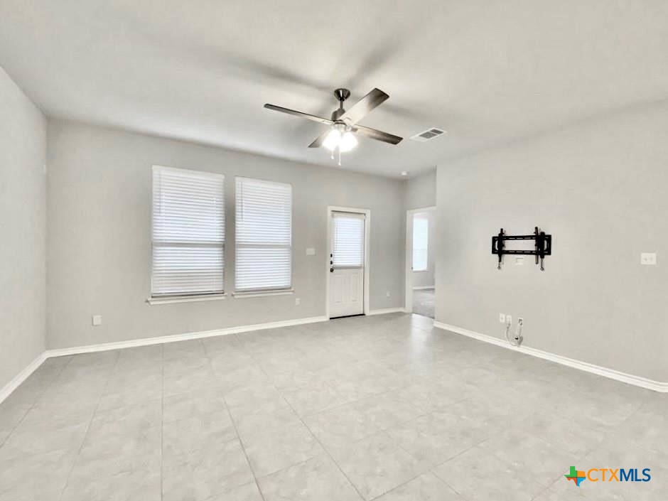 816 Alta Way Leander, TX 78641 - Photo 9 of 37 an empty room with windows and fan
