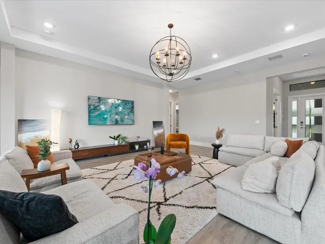 a large kitchen with lots of counter space dining table and stainless steel appliances