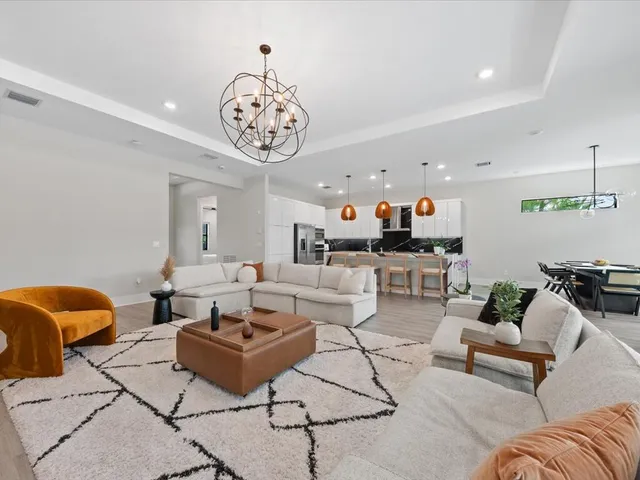 a kitchen with stainless steel appliances a stove and a large window