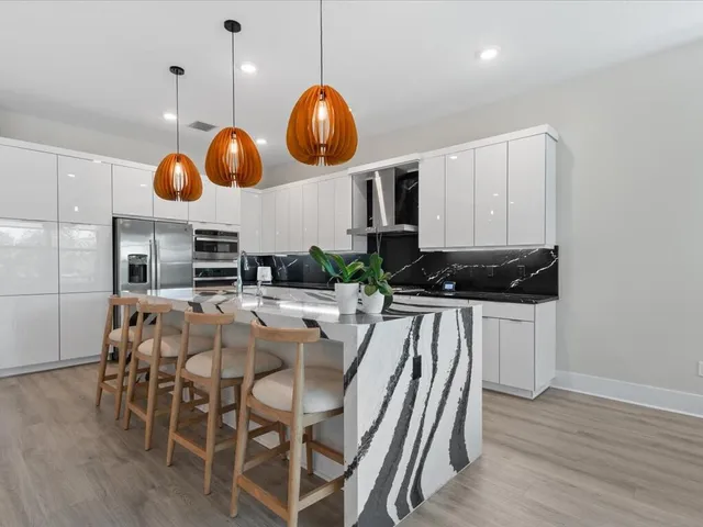 a kitchen with stainless steel appliances granite countertop a refrigerator sink and cabinets