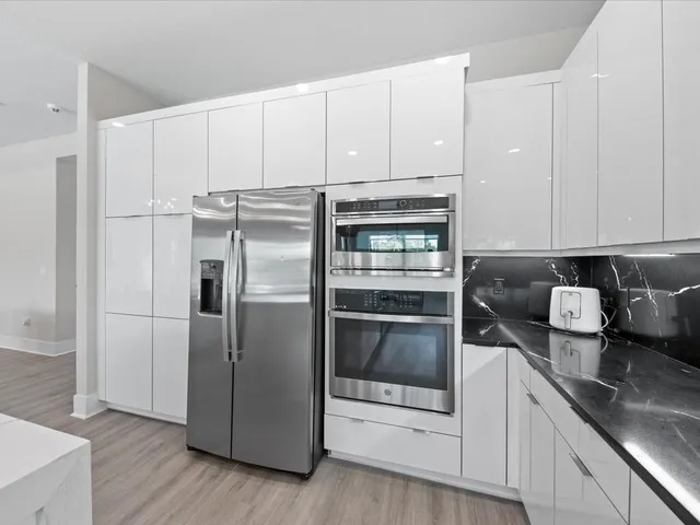 a large bed sitting in a bedroom next to a window