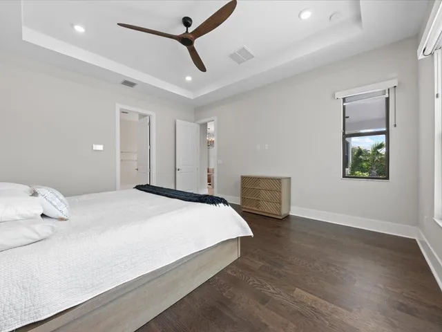 a bedroom with a bed and a ceiling fan