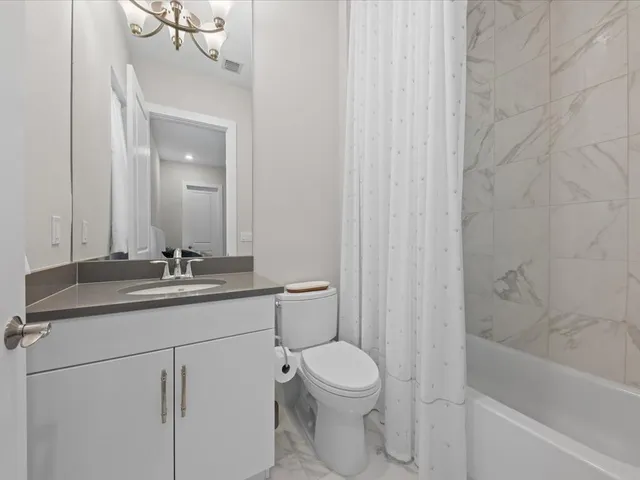 a front view of a house with a garden and plants