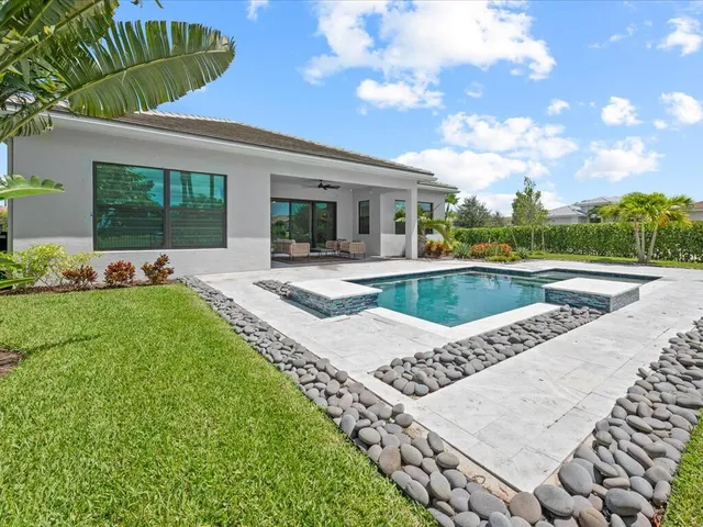 a view of a house with swimming pool and porch