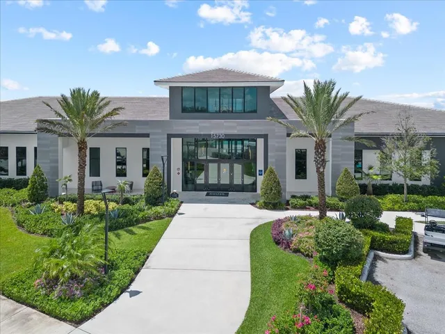 a view of a hallway with wooden floor and a bathroom