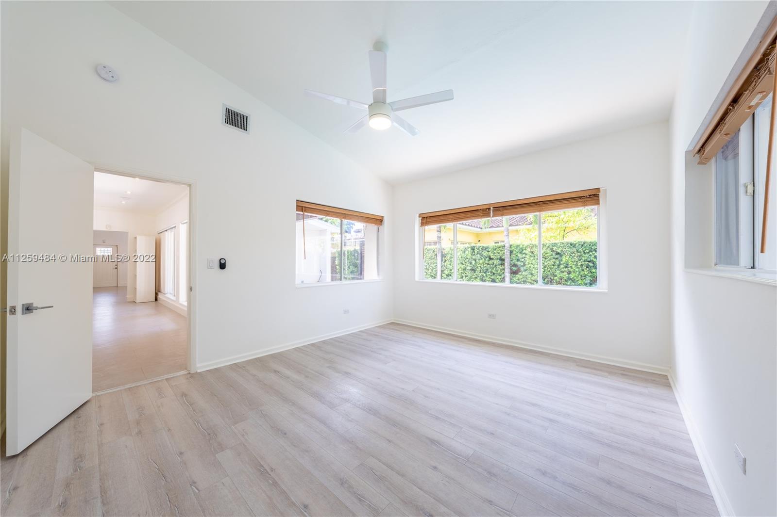 8810 Dickens Avenue Surfside, FL 33154 - Photo 11 of 15 wooden floor in an empty room with a window