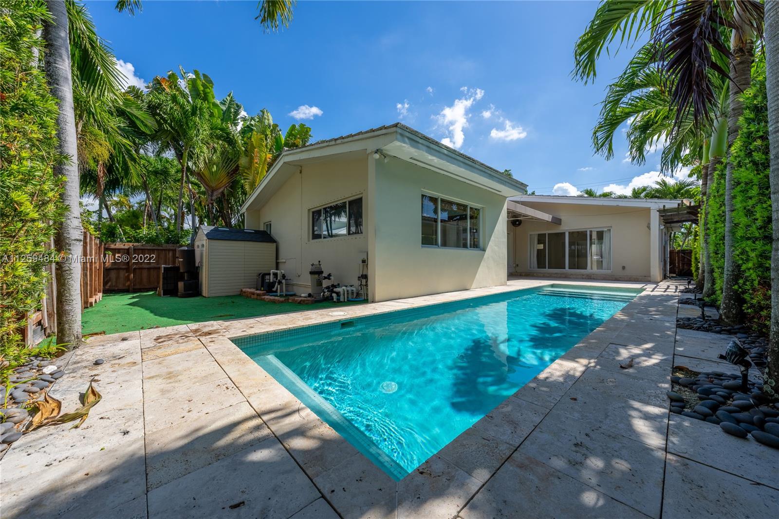 8810 Dickens Avenue Surfside, FL 33154 - Photo 13 of 15 a front view of house with yard and trees in the background