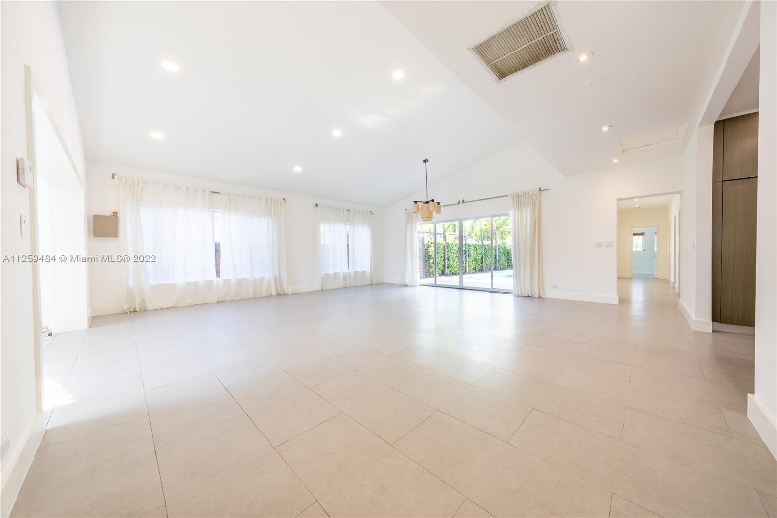 8810 Dickens Avenue Surfside, FL 33154 - Photo 2 of 15 a view of an empty room with a window