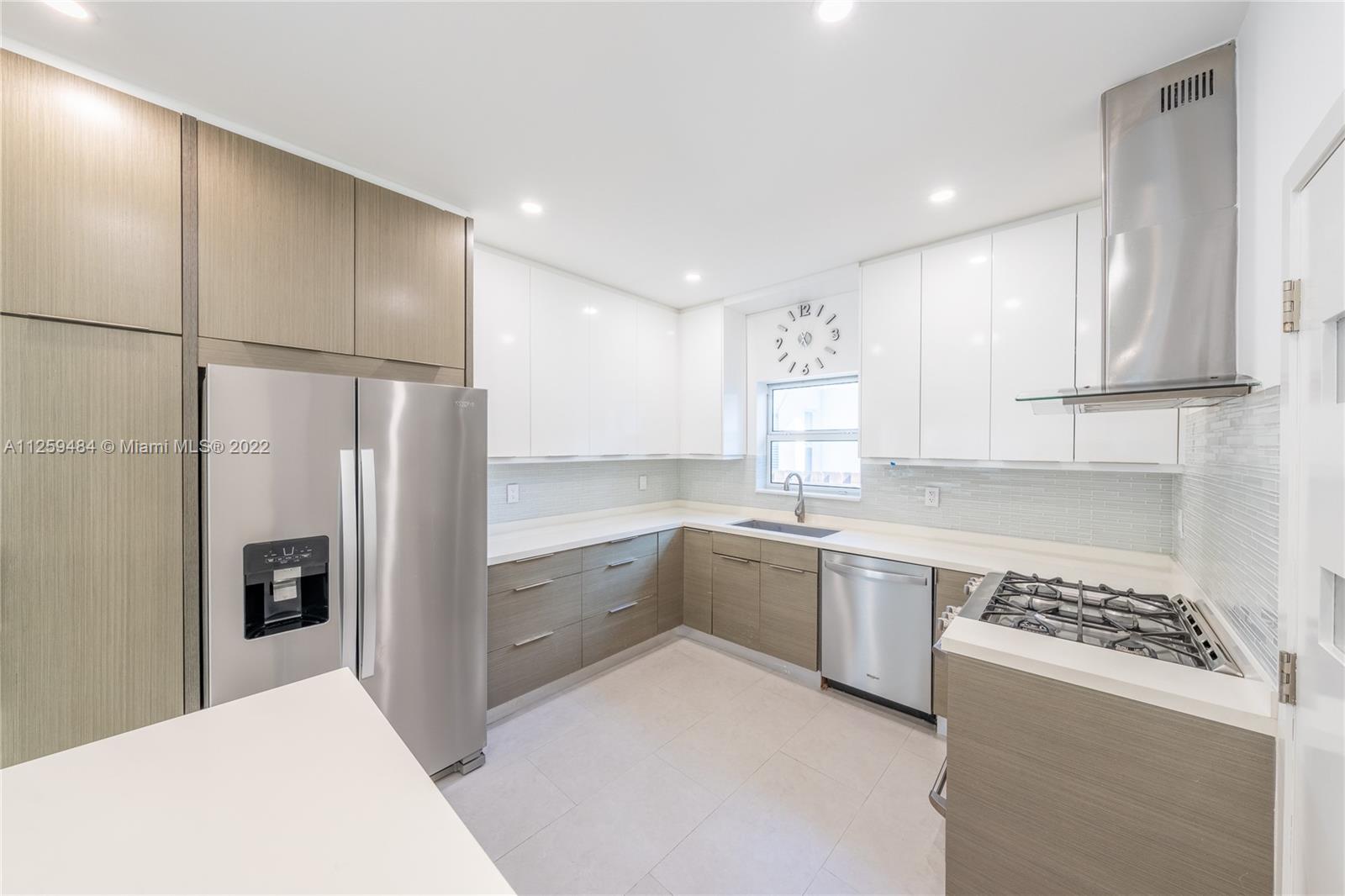 8810 Dickens Avenue Surfside, FL 33154 - Photo 6 of 15 a kitchen with stainless steel appliances granite countertop a refrigerator and a stove top oven