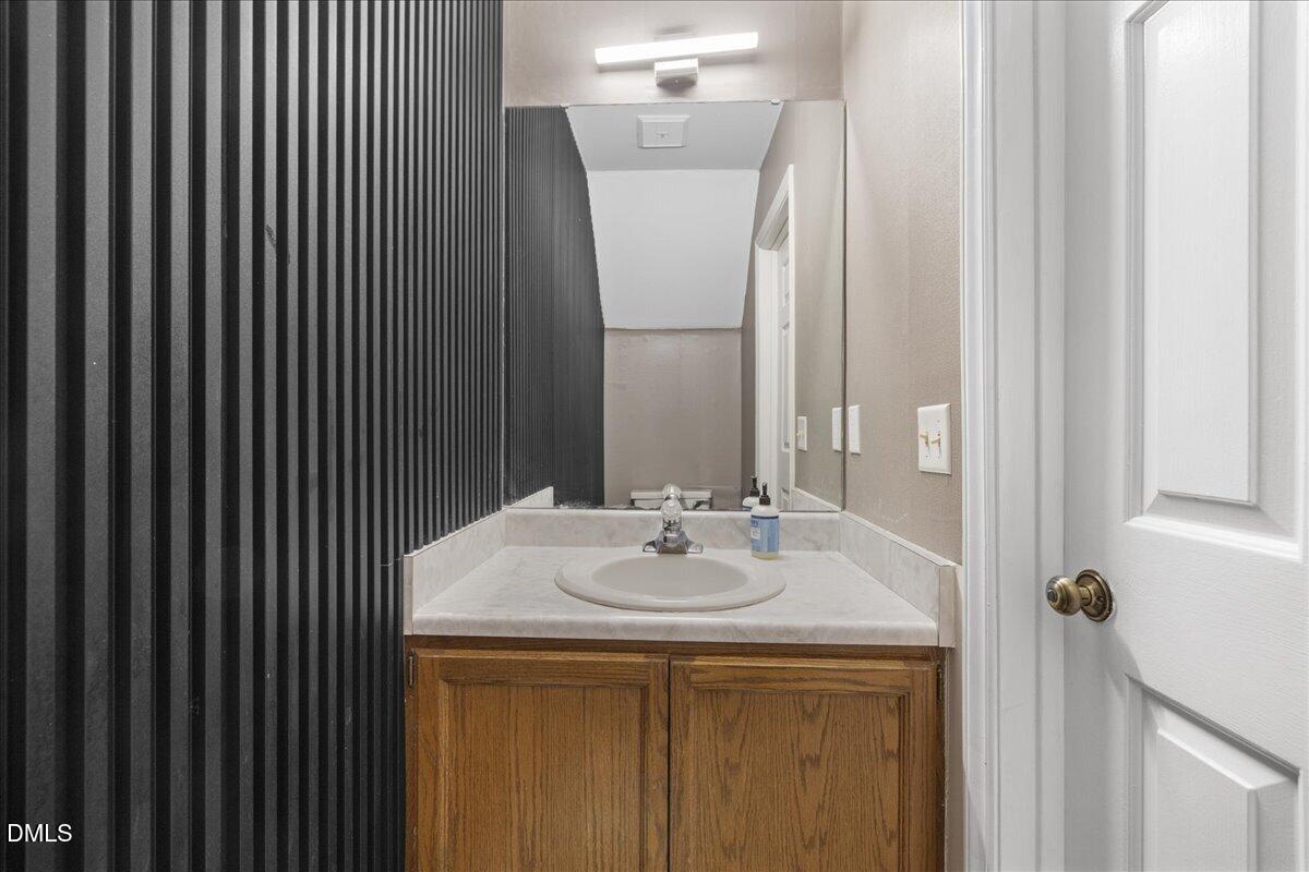 4 Astor Court Durham, NC 27705 - Photo 17 of 29 a bathroom with a sink and a mirror