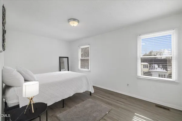 a bedroom with a bed and chair