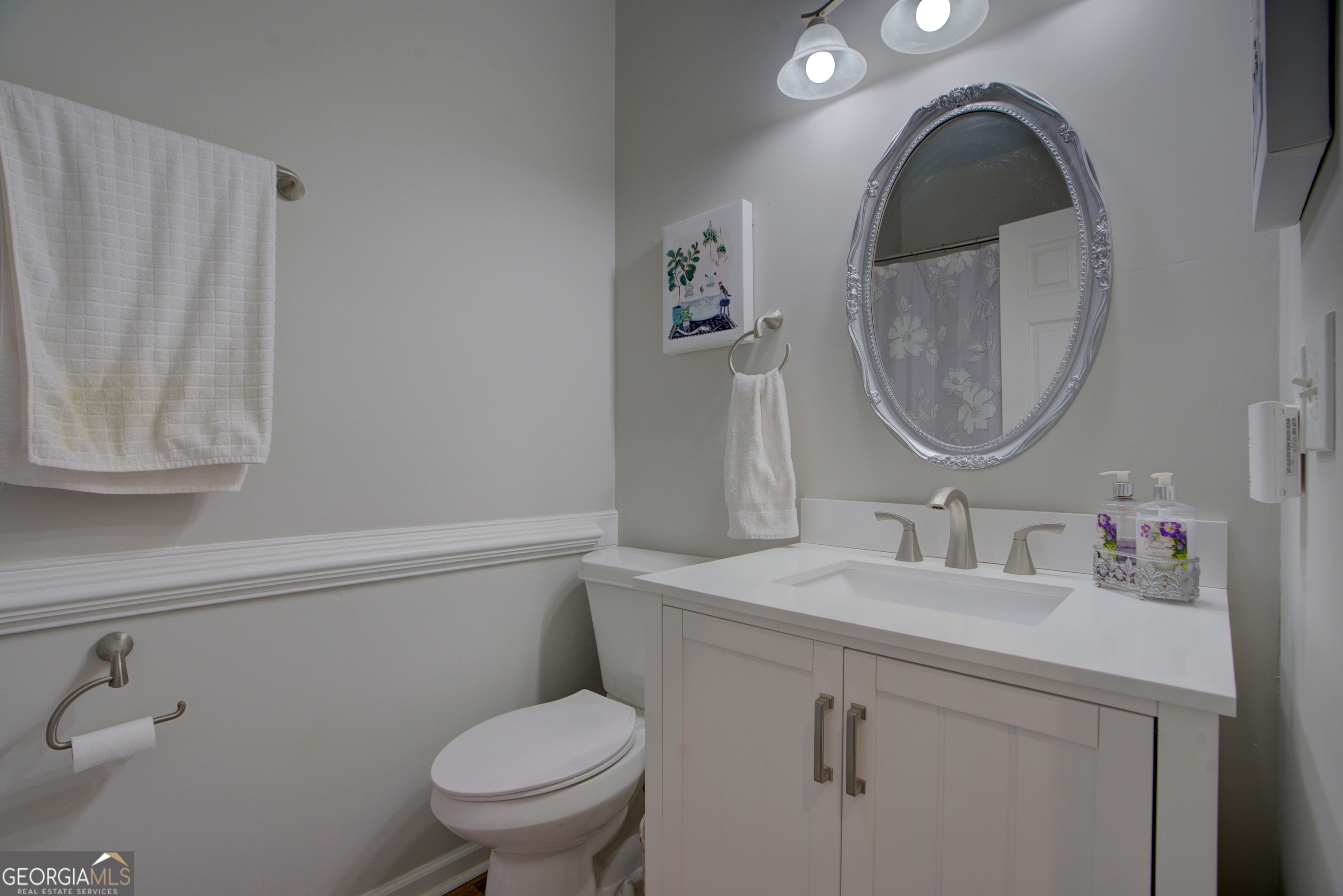 814 Manor Way Cartersville, GA 30120 - Photo 12 of 24 a bathroom with a granite countertop toilet sink and mirror