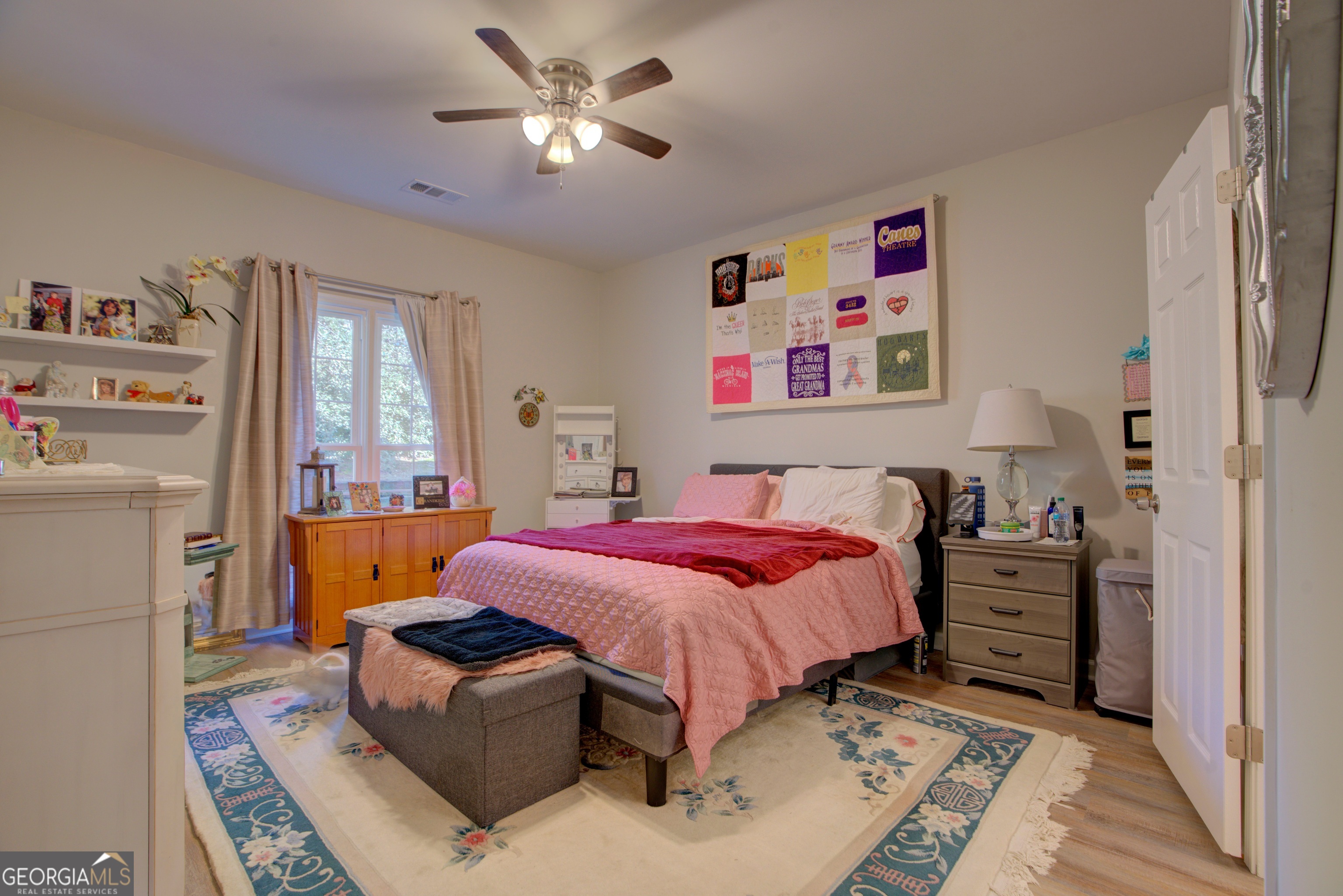 814 Manor Way Cartersville, GA 30120 - Photo 16 of 24 a bedroom with a bed and a chandelier